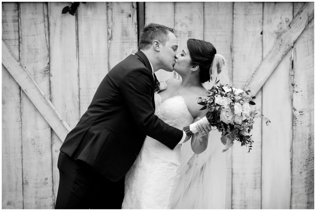 dramatic romantic black and white photo of bride and groom after wedding ceremony