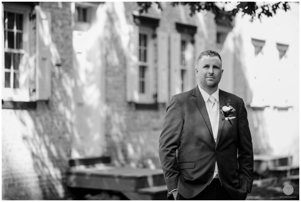 black and white photo of groom at allaire state park
