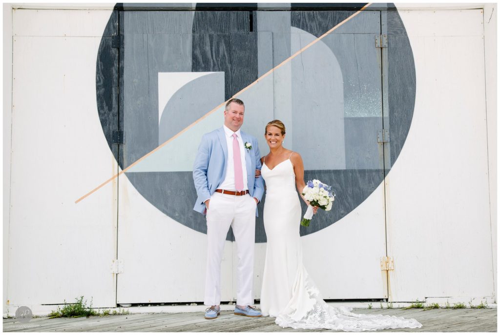 bride and groom in front of mural in Asbury Park NJ