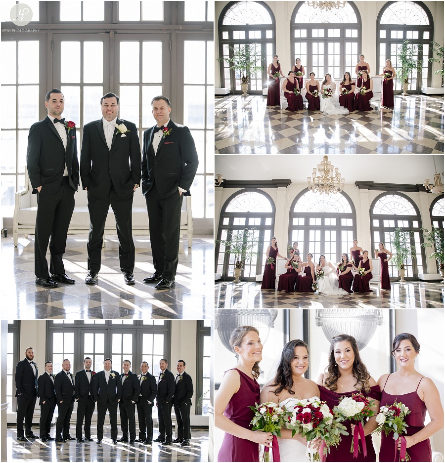 bridal party in maroon dresses stand in large lobby at the berkeley hotel in asbury park 