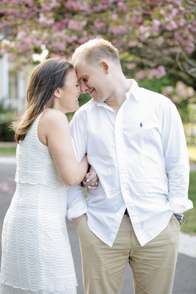 Couple under cherry blossom in spring lake engagement session