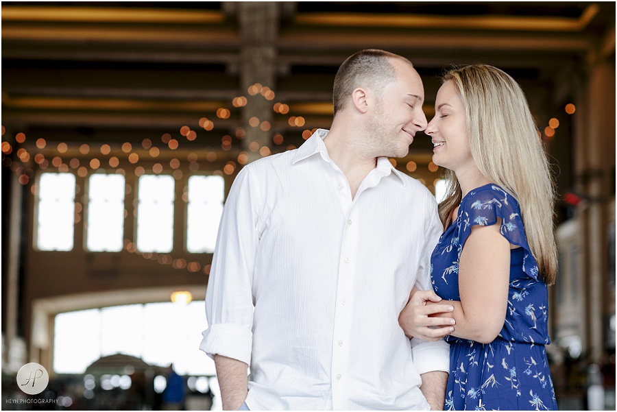 couple snuggling in Convention hall in Asbury Park engagement session jersey shore 