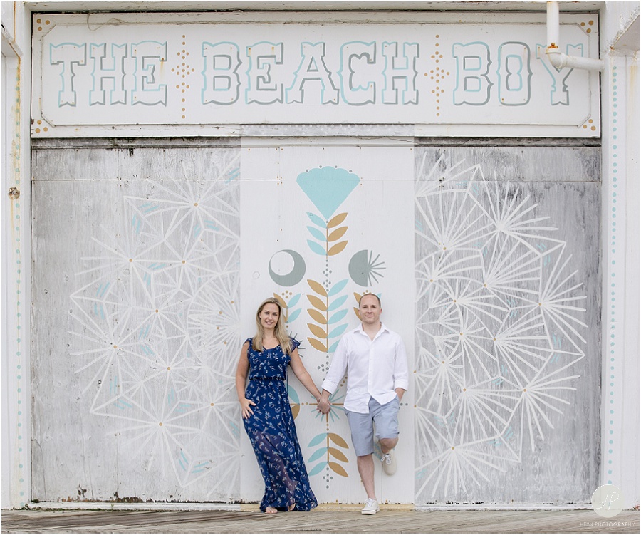 couple standing in front of mural in Asbury Park engagement session jersey shore 