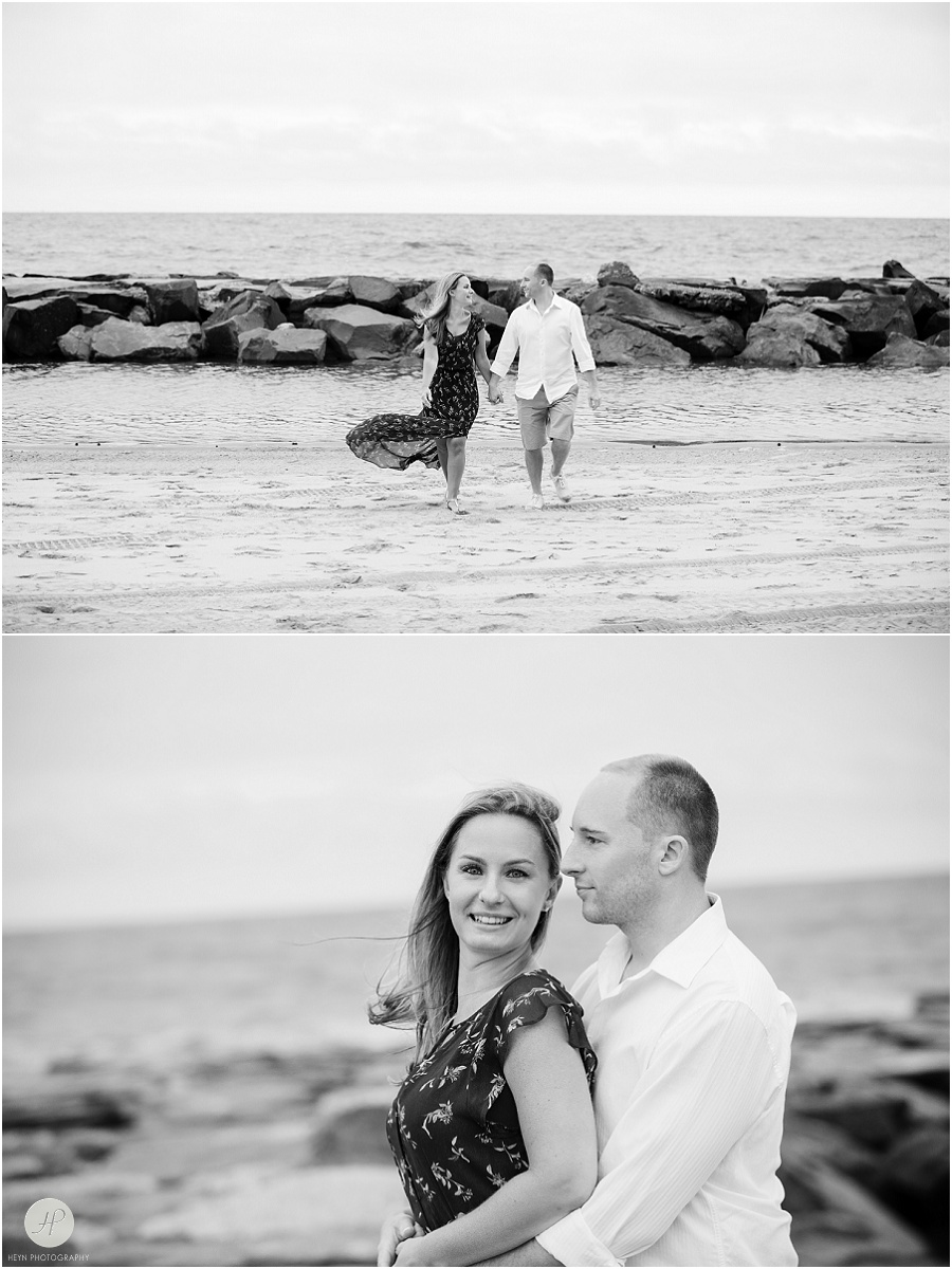  couple walking on beach in Asbury Park engagement session jersey shore 