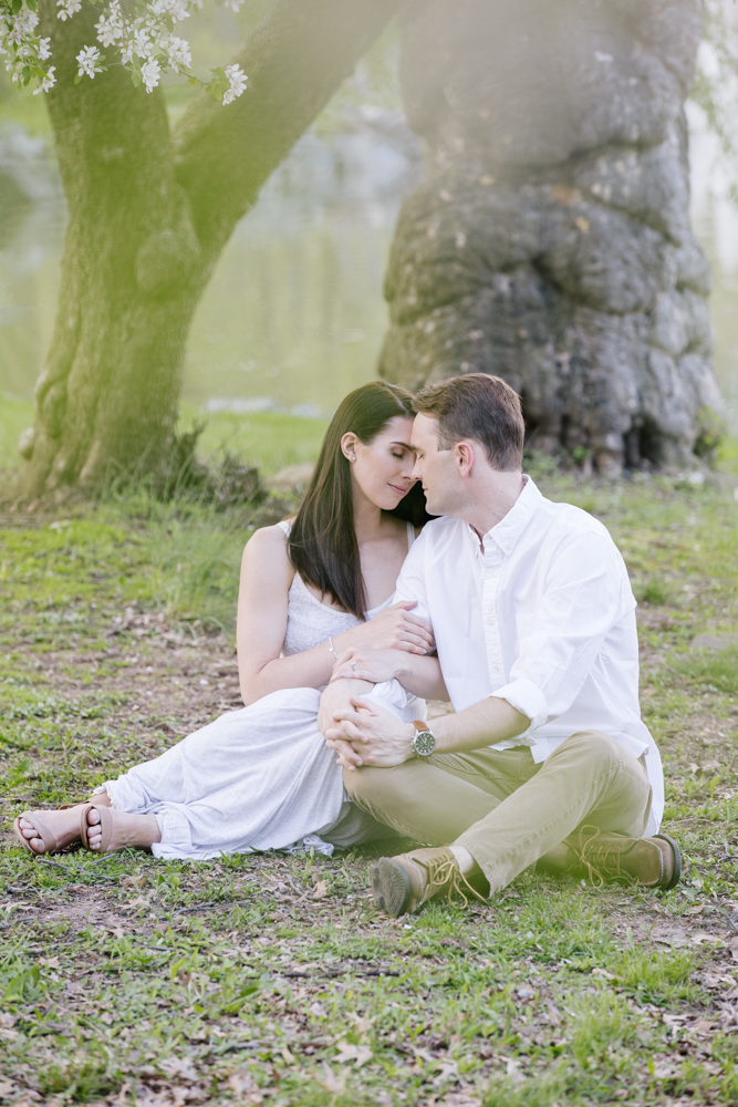 couple sitting in park in downtown westfield engagement session in new jersey