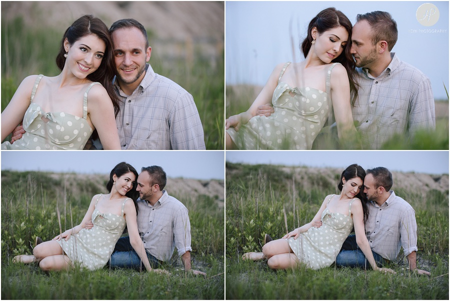  engaged couple sitting in tall grass at dusk in downtown spring lake engagement session