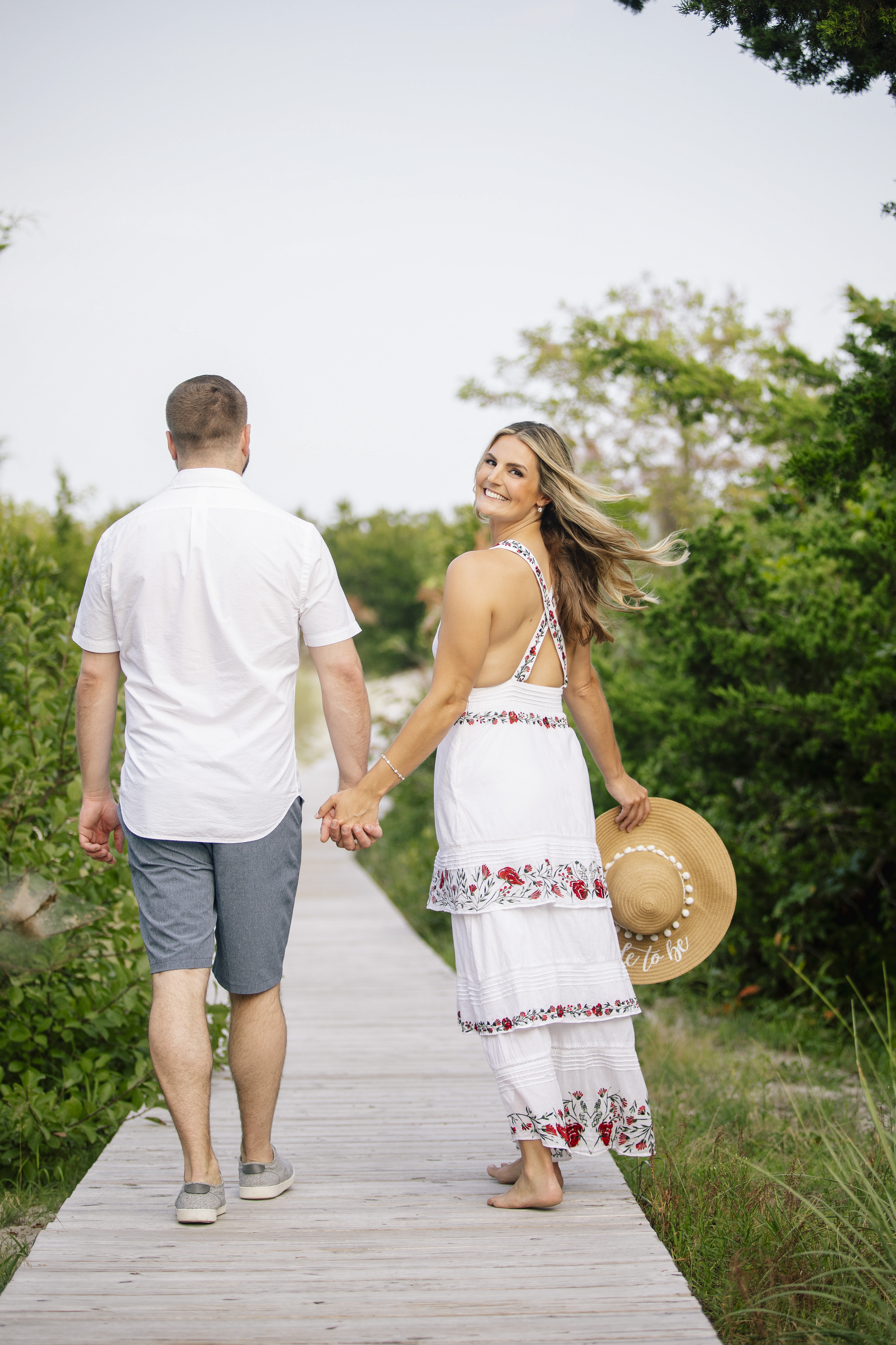 couple walking on beach on long island engagement session