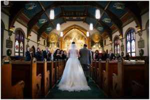 bride walking down the aisle at saint peters church in point pleasant new jersey