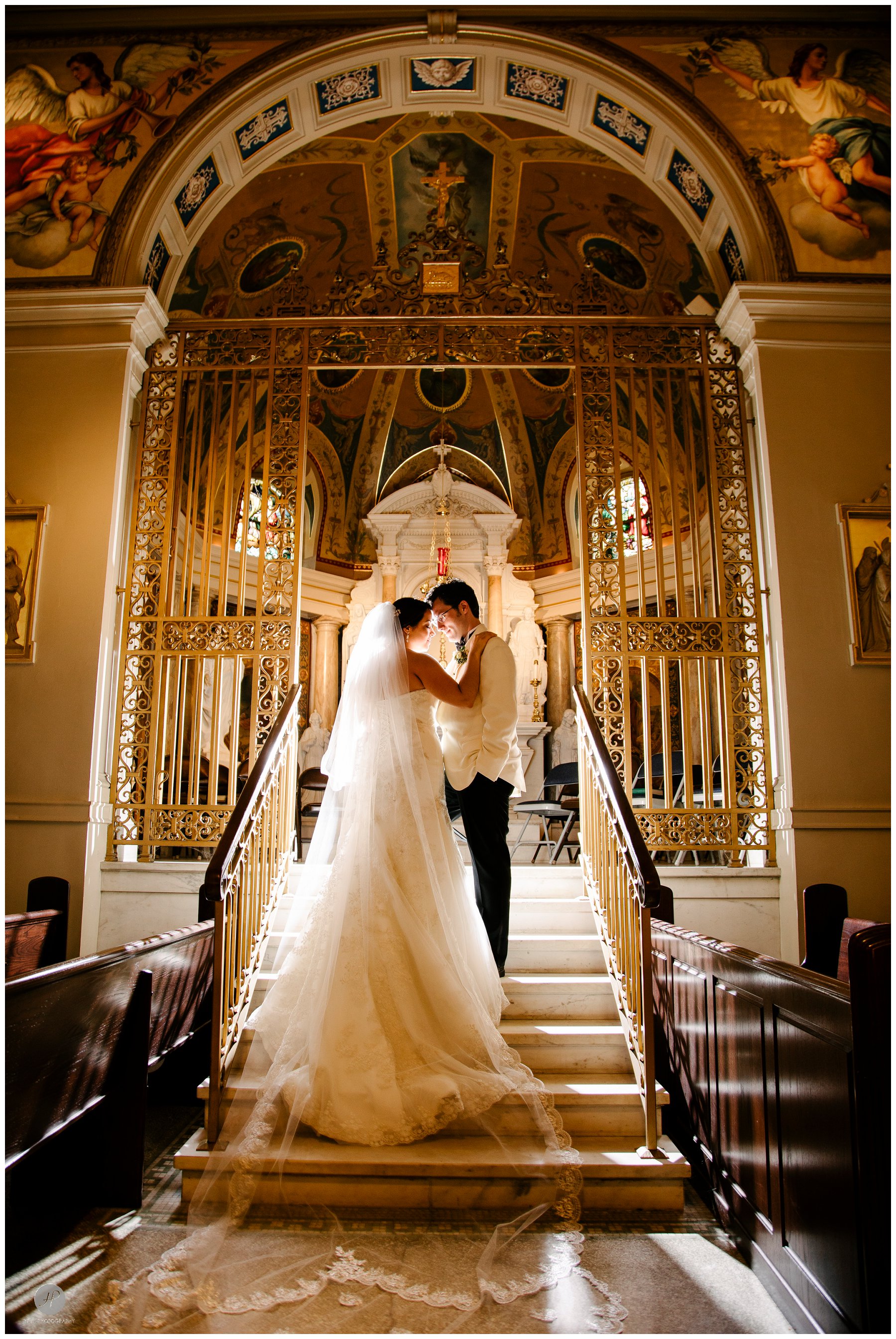 romantic dramatic photo of bride and groom inside cathedral